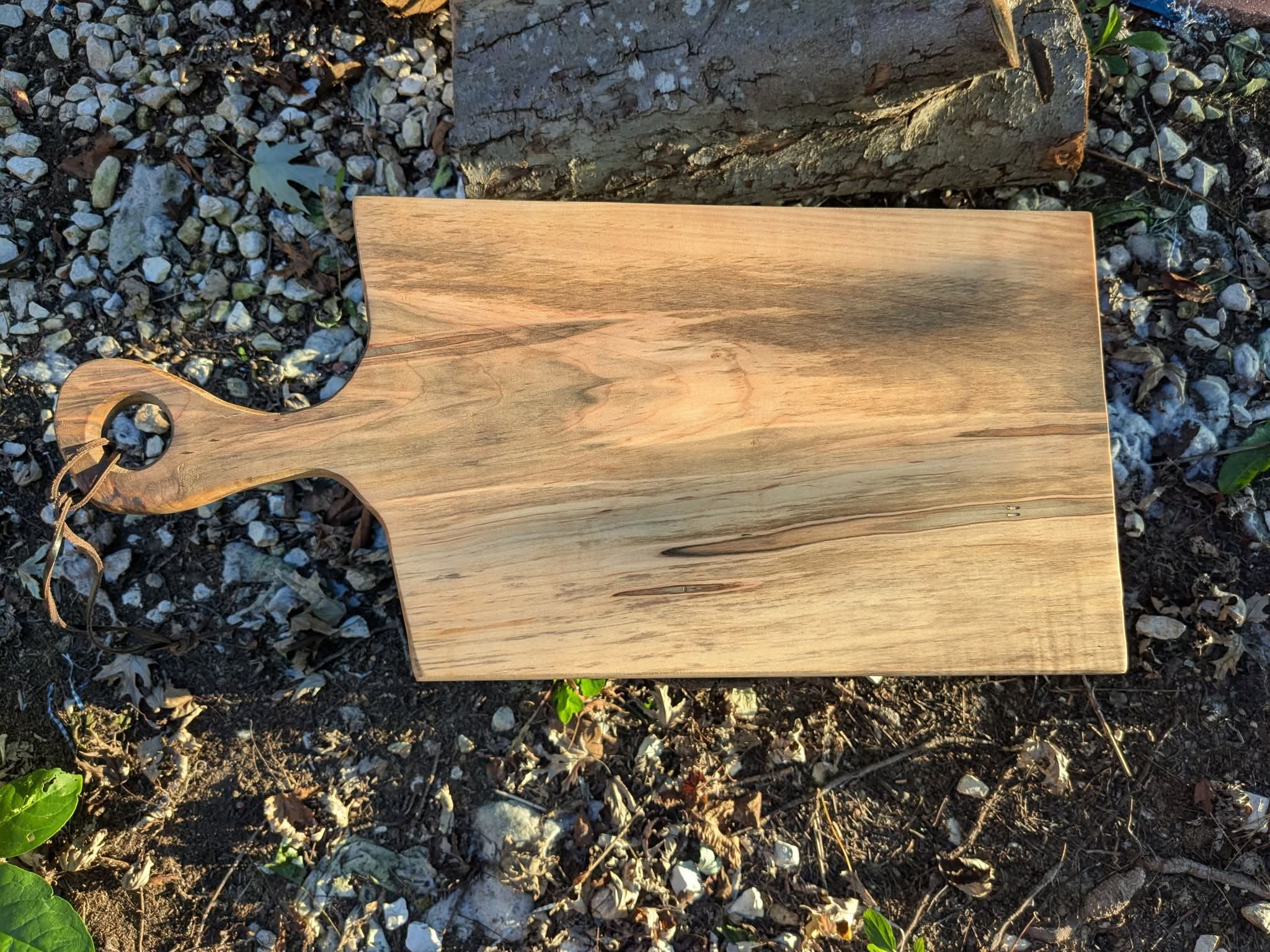 Ambrosia maple charcuterie board with leather accent